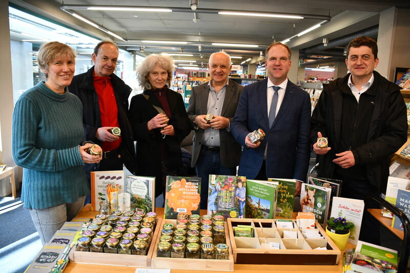 Bürgermeister Dirk Breuer (2.v.r.) und Dr. Rolf Meier (3.v.r.) präsentierten mit Beteiligten der Saatgutbörse unterschiedliche Saatarten in Gläsern.
